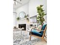 Cozy living room with a fireplace, a blue accent chair, and neutral decor at 201 N Hillside Dr. # 311-A, North Myrtle Beach, SC 29582