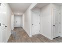 Inviting hallway featuring neutral walls, wood-look floors and white doors that adds a touch of elegance to the home at 211 Seasons Trace Loop, Longs, SC 29568