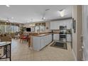 Open-concept kitchen with white cabinets, stainless appliances, and dining area at 215-B S Dogwood Dr., Surfside Beach, SC 29575