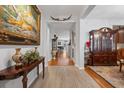 Elegant foyer featuring hardwood floors, decorative vases, artwork, and intricate wood furniture at 2170 Buxton Dr., Myrtle Beach, SC 29579