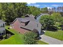 An aerial view showcasing the home's roof, landscaping, and surrounding trees in a lush, green neighborhood at 2302 Clandon Dr., Myrtle Beach, SC 29579