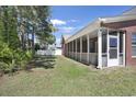 Spacious backyard featuring a screened-in porch and ample green space perfect for outdoor activities and relaxation at 2302 Clandon Dr., Myrtle Beach, SC 29579