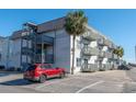 Condo building with multiple balconies, outdoor stairs and parking at 300 47Th Ave. S # 1E, North Myrtle Beach, SC 29582