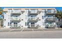 Condo building featuring multiple balconies and parking at 300 47Th Ave. S # 1E, North Myrtle Beach, SC 29582