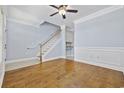 Bright, open living room with hardwood floors, a staircase, and crown molding at 3550 Pampas Dr. # 2, Myrtle Beach, SC 29577