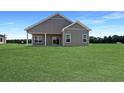 Well-maintained backyard featuring lush green grass and an inviting covered patio at 3597 Valley Forge Rd., Aynor, SC 29511
