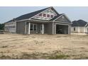 Newly built home exterior shows a covered porch, two-car garage, and backyard at 3597 Valley Forge Rd., Aynor, SC 29511