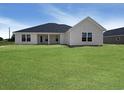 The back of this home features bright white trim, a covered back porch, and a spacious, bright green yard at 3601 Valley Forge Rd., Aynor, SC 29511