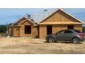 Exterior view of home under construction, showcasing the architectural design, framing, and ongoing roofing work at 3601 Valley Forge Rd., Aynor, SC 29511