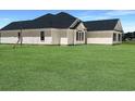 The side of this home features bright white vinyl siding, black shutters, and a spacious, bright green yard at 3601 Valley Forge Rd., Aynor, SC 29511