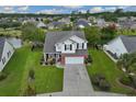 Aerial view of a two-story home with a manicured lawn in a residential neighborhood at 417 Pennington Loop, Myrtle Beach, SC 29588