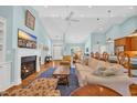 Bright and airy living room with a fireplace, hardwood floors, and open-concept design at 455 Dornoch Dr., Pawleys Island, SC 29585