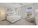 Bright bedroom featuring plush carpet, large windows with curtains, and a decorative chair at 543 Oak Landing Dr., Myrtle Beach, SC 29588