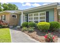Close up of the exterior featuring well-manicured shrubs and front door at 558 Juniper Dr., Myrtle Beach, SC 29577