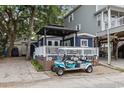 Charming beach home featuring a welcoming porch area and a convenient golf cart for easy transportation at 6001- 1771 S Kings Highway, Myrtle Beach, SC 29575
