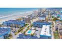 Aerial view of beach condos with a community pool near the coastline at 6001 N Ocean Blvd. # 240, North Myrtle Beach, SC 29582