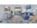 Cozy living room showcasing a large sofa and sliding glass doors leading to a balcony at 6001 N Ocean Blvd. # 240, North Myrtle Beach, SC 29582