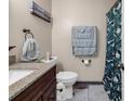 Cozy bathroom featuring granite countertop and complementing blue towels at 6628 Mallard View Point, Myrtle Beach, SC 29588