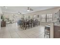 Bright, open-concept living and dining area with tile floors, ceiling fans, and ample natural light through large windows at 703 37Th Ave. S, North Myrtle Beach, SC 29582