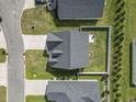 Aerial view showcasing the home's roof, driveway, and surrounding landscape in a residential area, from directly above at 712 Hobonny Loop, Longs, SC 29568