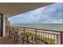 Balcony with comfortable seating overlooking the ocean and beach at 7200 N Ocean Blvd. # 1058, Myrtle Beach, SC 29572