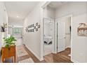 Hallway with wood floors leading to the bedroom and living room, decorated with wall art at 747 Gryffindor Dr., Longs, SC 29568