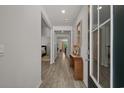 Bright hallway featuring durable floors, neutral paint, and a clear view of other rooms at 847 Flowering Branch Ave., Little River, SC 29566