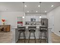 Bright kitchen featuring granite countertops, stainless appliances, barstool seating, and plenty of cabinet space at 847 Flowering Branch Ave., Little River, SC 29566