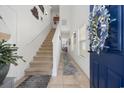 Bright entryway with staircase, stylish decor, and tiled floors, leading into the home at 903 Ocean Pines Ct., North Myrtle Beach, SC 29582