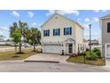 Charming two-story home featuring blue shutters, attached two-car garage, and landscaped front yard at 903 Ocean Pines Ct., North Myrtle Beach, SC 29582