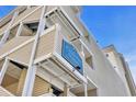 Low angle shows Palmetto Dunes signage on a light cream sided building under blue sky at 1011 S Ocean Blvd. # 202, North Myrtle Beach, SC 29582