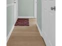 Hallway has light wood floors with a 'welcome' door mat at the entrance at 1011 S Ocean Blvd. # 202, North Myrtle Beach, SC 29582