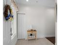 Bright entryway featuring a charming accent table, closet, and decorative wreath on the front door at 1025 World Tour Blvd. # 301, Myrtle Beach, SC 29579