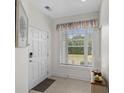 Inviting foyer with a large window and a charming accent table that enhances the entryway's appeal at 1025 World Tour Blvd. # 301, Myrtle Beach, SC 29579