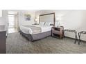 This bedroom has a queen bed, nightstand with lamp, luggage rack and neutral decor at 1105 South Ocean Blvd. # 1008, Myrtle Beach, SC 29577