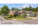 Beautiful single-story home on a corner lot with lush landscaping, and an attached two-car garage at 1129 Prescott Circle, Myrtle Beach, SC 29577