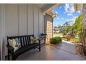 Inviting front porch with a bench, decorative pillows, potted plants, and a charming garden at 1129 Prescott Circle, Myrtle Beach, SC 29577