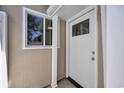 The front door is next to a window and has white trim and a dark-colored door knob at 1361 Turkey Ridge Rd. # C, Surfside Beach, SC 29575