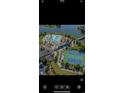Aerial view of community amenities, including a pool, tennis courts, and clubhouse overlooking the lake at 209 Bouquets Green Way, Myrtle Beach, SC 29579