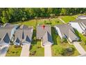 Aerial view of homes in a residential neighborhood with mature trees and well-manicured lawns, plus backyard fencing at 2446 Craven Dr., Myrtle Beach, SC 29572