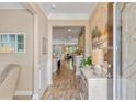 Inviting foyer with decorative wall trim and wood-look tile flooring, plus a glimpse into the open concept living spaces at 2446 Craven Dr., Myrtle Beach, SC 29572
