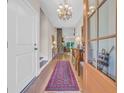 Elegant entryway featuring wood floors, a bright chandelier, and a clear view into the living area at 25 Northwoods Ct., Pawleys Island, SC 29585