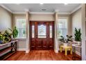 Inviting foyer with hardwood floors, stained-glass front door, side windows, and lush plants at 2767 Lees Landing Circle, Conway, SC 29526