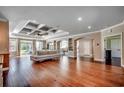 Spacious living room with hardwood floors, coffered ceiling and open access to the kitchen at 2767 Lees Landing Circle, Conway, SC 29526