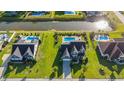 Aerial view of a backyard oasis with a private pool, surrounded by lush greenery and a serene waterway at 304 San Martin Ct., Longs, SC 29568