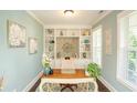 Stylish home office with built-in shelving, light blue walls, and a window for natural light at 304 San Martin Ct., Longs, SC 29568