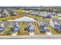 Expansive aerial view of a residential community featuring numerous homes surrounding a serene pond and lush green spaces at 3119 Hannon Dr., Myrtle Beach, SC 29579