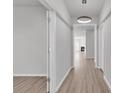 Bright hallway featuring wood floors, modern lighting, and open doorways leading to other rooms in the home at 3119 Hannon Dr., Myrtle Beach, SC 29579