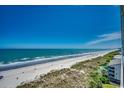 Expansive beach view, capturing the serene shoreline and clear blue sky, from the condo at 3601 S Ocean Blvd. # 8-C, North Myrtle Beach, SC 29582