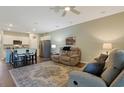 Open concept living space with sofas, kitchen island, stainless steel appliances, and hardwood floors at 3766 Bells Lake Circle # 3766, Longs, SC 29568